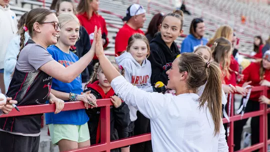 Keeley Block high-fiving a fan at SECU Stadium