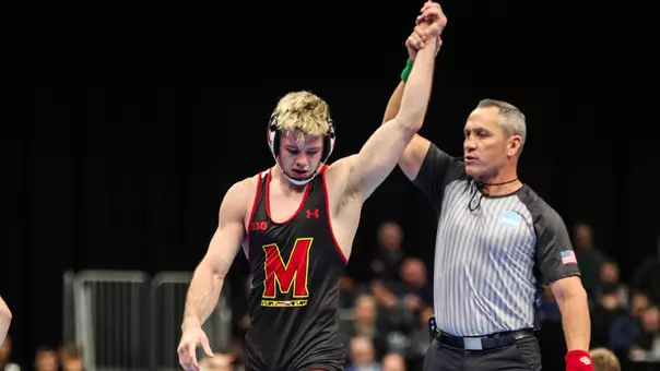 Carter Young gets his hand raised after advancing to the NCAA QF