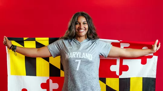 Studio photo of Faith Luckey holding a Maryland flag
