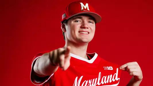 Landon Edwards Story Cover Photo - posing in front of red background pointing at camera