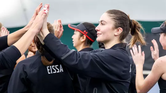 Tamari Gagoshidze high-fiving her teammates before a match