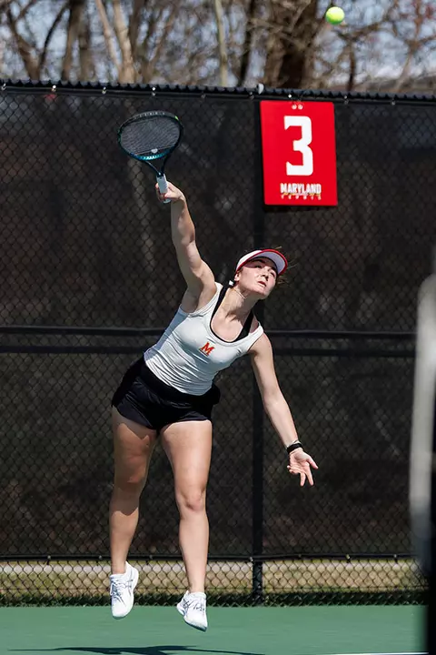Tamari Gagoshidze serving during a Maryland tennis match
