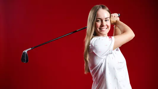 Emily McKee posed red background