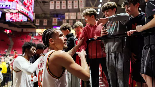 Collin Metcalf greeting fans at a Maryland men's basketball game