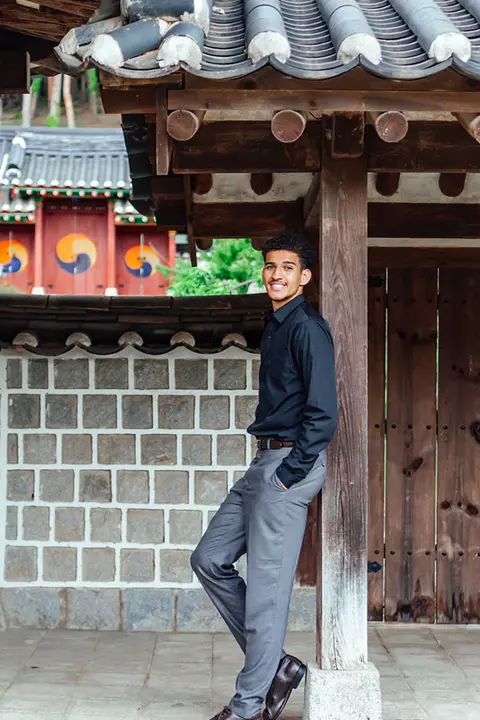 Collin Metcalf leaning against a pillar in Korea