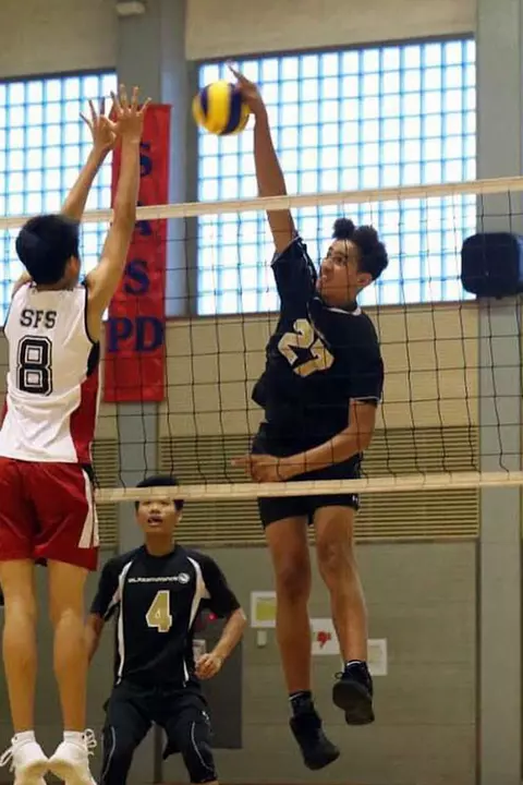 Collin Metcalf playing volleyball as a youth
