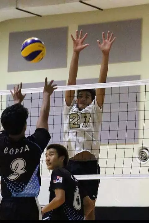 Collin Metcalf playing volleyball as a youth