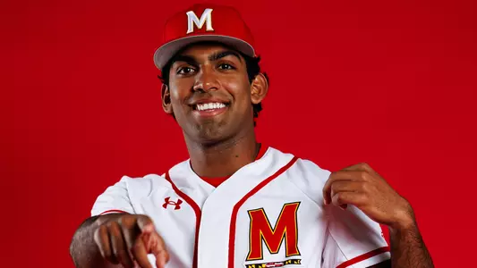 Story Cover Photo - Andrew Koshy posing in front of a red background pointing at the camera