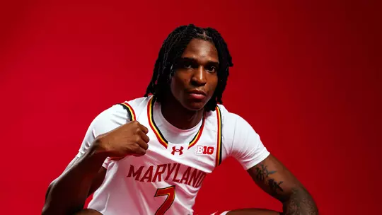 Studio photo of Andre Mills on a red background