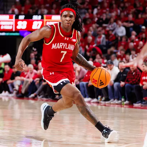 Andre Mills dribbling a basketball during a game for Maryland men's baskletball