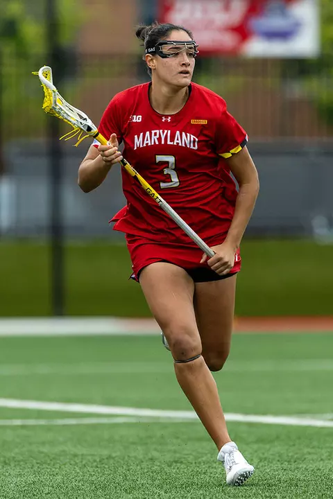 Kristen Shanahan running with a lacrosse stick