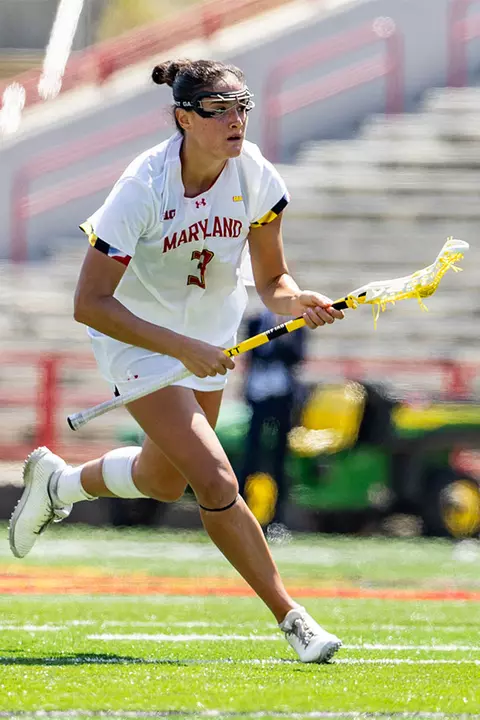 Kristen Shanahan running with a lacrosse stick
