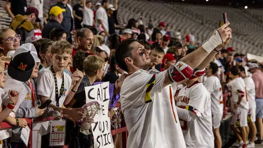 Eric Spanos taking a selfie with fans at SECU Stadium