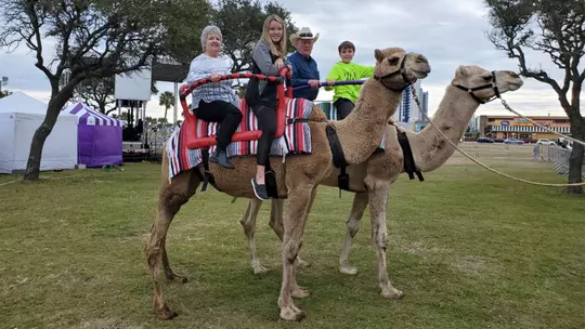Jaylee Williams as a youth riding camels with her family