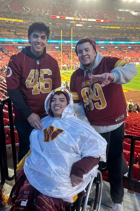 David and Diego Mendez with a friend at a Washington Commanders game