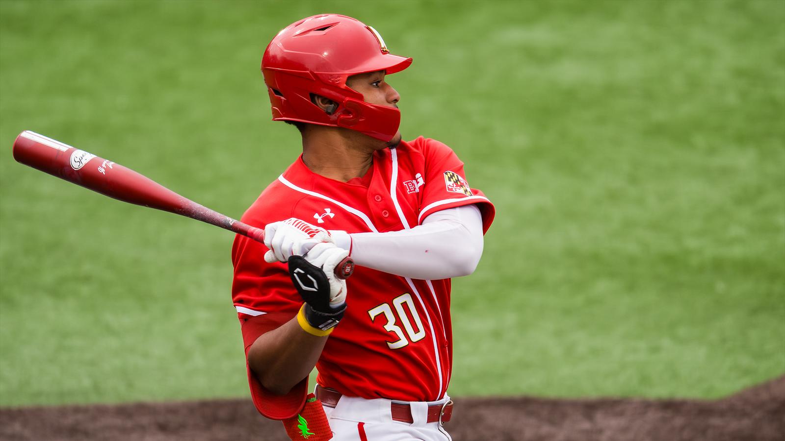 Paul Jones II hitting in a red uniform vs. Purdue