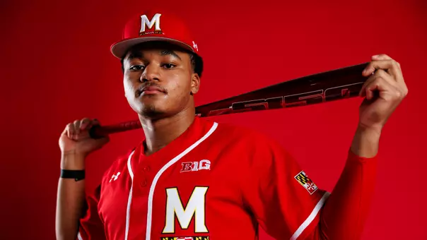 Paul Jones II - Story cover Photo, posing in front of red background with bat in hands