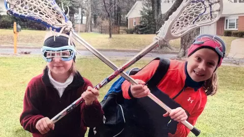Maddy Sterling with her sister Emily as youth lacrosse players