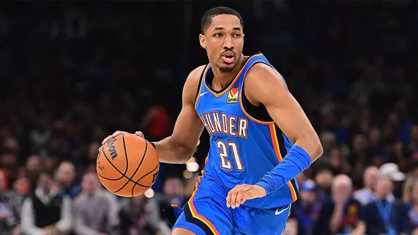 Aaron Wiggins dribbles a basketball in an NBA game for the Oklahoma City Thunder