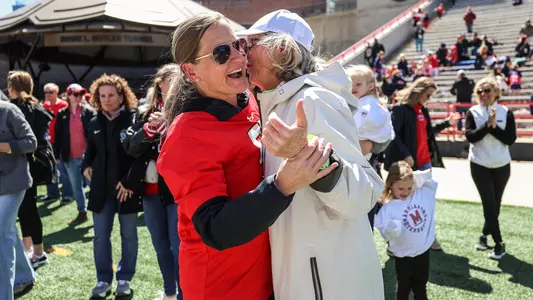 Cindy Timchal and Cathy Reese hugging at alumni event