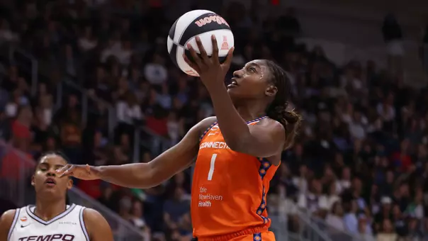 Diamond Miller drives to the basket for the Connecticut Sun - WNBA