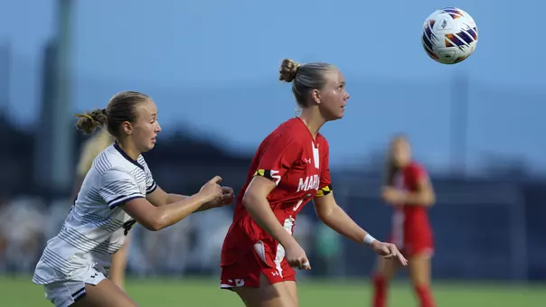 Jolie Farmer battles for possession against Navy