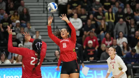 Sara Toth sets a ball against Purdue
