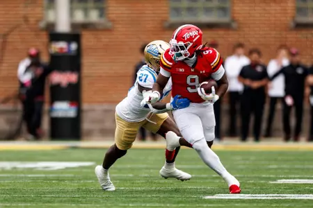 Dorian Fleming breaks a catch against UCLA