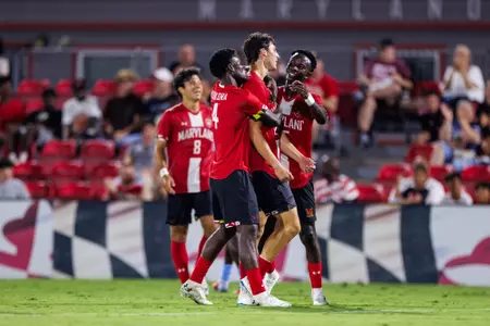 Jason celebrates with his teammates on the field