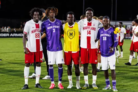 Jason poses with teammates and opponents after the game