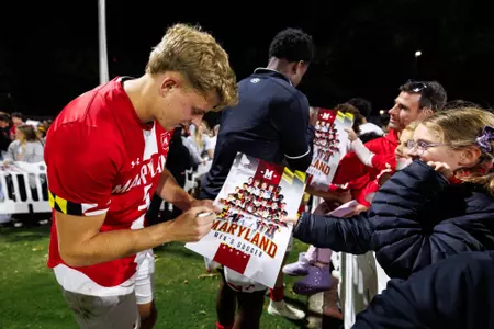 Ljubomir signs an autograph for a fan postgame