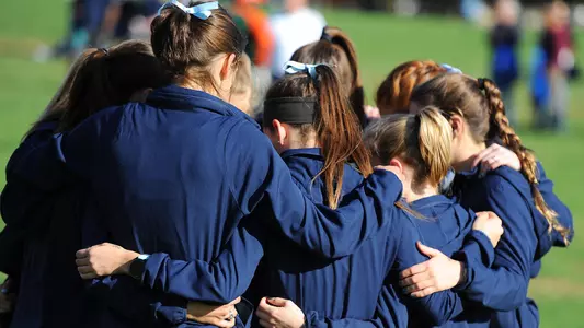 Cross Country women's team huddle