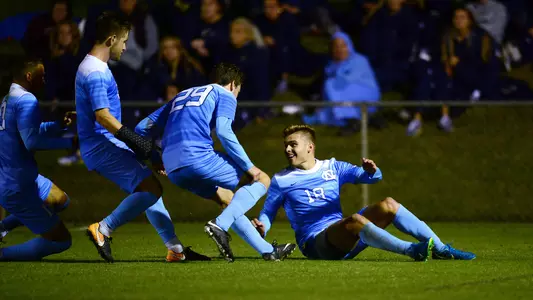 Alan Winn (18) and the Tar Heels celebrate against Notre Dame.