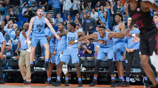 UNC bench celebrates Pinson's dunk