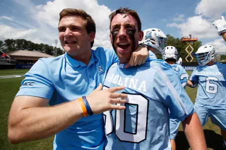 Patrick McCormick #9 celebrates with goalkeeper Brian Balkam #30 of the North Carolina Tar Heels (Photo by Peyton Williams)