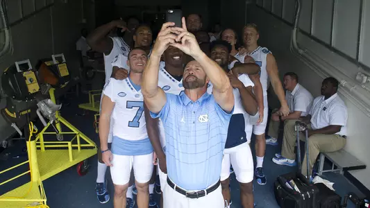 Larry Fedora takes a selfie with members of his team.