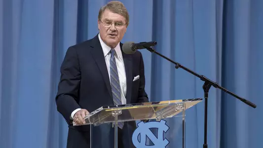 John Swofford makes remarks during the Woody Durham memorial service in Carmichael Arena, Sunday, April 8, 2018 in Chapel Hill, N.C. The former play-by-play announcer died at the age of 76 on March 7. (UNC Athletic Communications/Jeffrey A. Camarati).