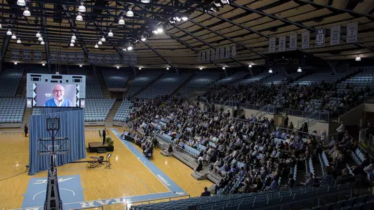 Attendees listen to remarks during the Woody Durham memorial service in Carmichael Arena, Sunday, April 8, 2018 in Chapel Hill, N.C. The former play-by-play announcer died at the age of 76 on March 7. (UNC Athletic Communications/Jeffrey A. Camarati).