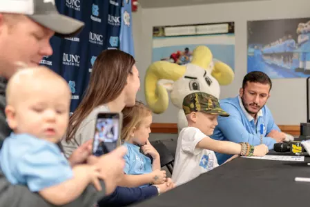 Mason Fannin signing at his Team IMPACT signing day