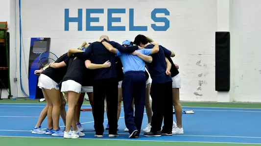 The Tar Heels huddle on the court.