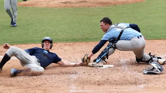 Brendan Illies (43) tags out Ike Freeman (8) at home.