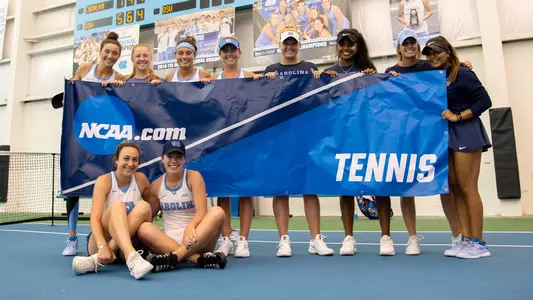 W Tennis team with banner, celebration