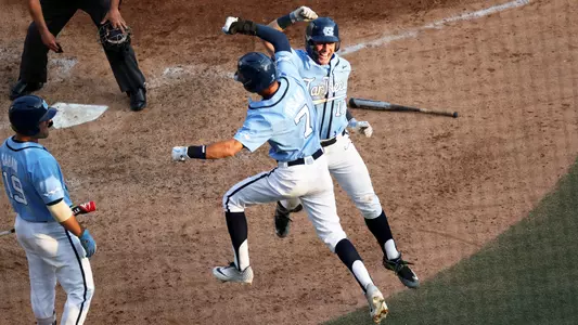 Michael Busch and Dallas Tessar celebrate Busch's two-run homer in the seventh.
