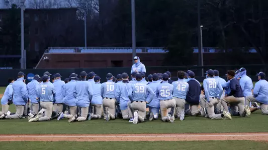 Coach Forbes (21) talks to the team following the scrimmage.