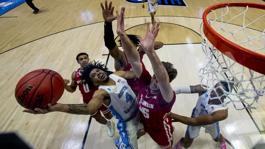 WEST LAFAYETTE, IN - MARCH 19: RJ Davis tries to get off a shot while swarmed by the Wisconsin defense in the first round of the 2021 NCAA Division I Men’s Basketball Tournament held at Mackey Arena on March 19, 2021 in West Lafayette, Indiana. (Photo by Andy Hancock/NCAA Photos/NCAA Photos via Getty Images)