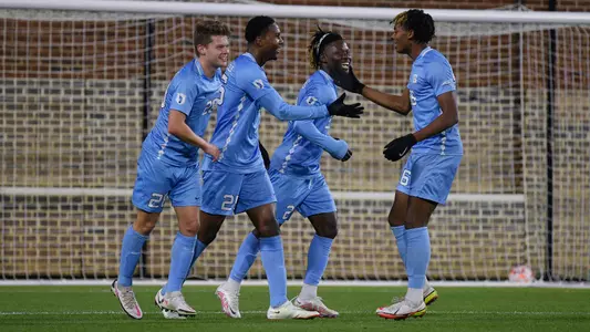 The Tar Heels celebrate scoring against Virginia.