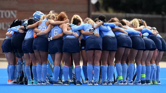 The Tar Heels huddle on the field.
