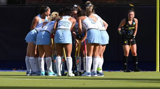 The Tar Heels huddle on the field.