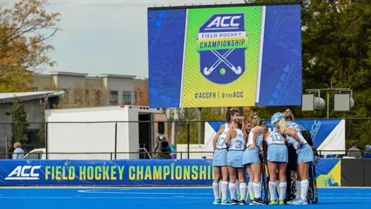 The Tar Heels huddle on the field.
