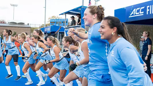 The UNC bench begins to celebrate the victory.